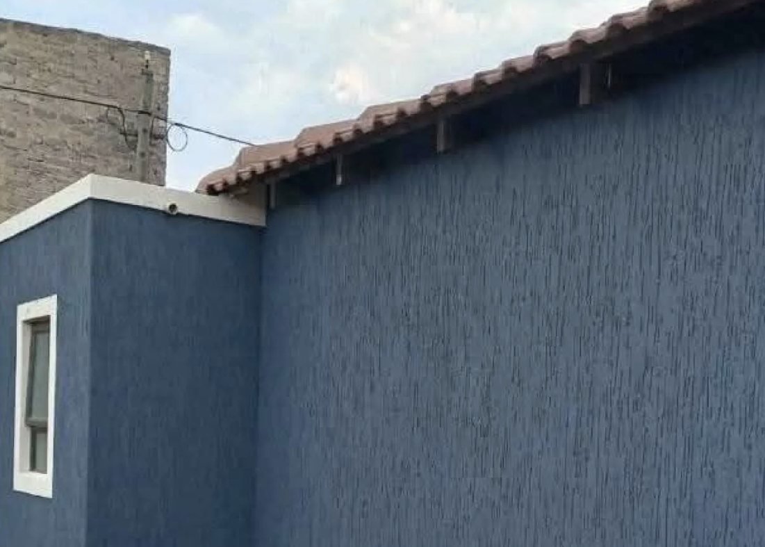 After: wall finished in a fresh blue textured coating